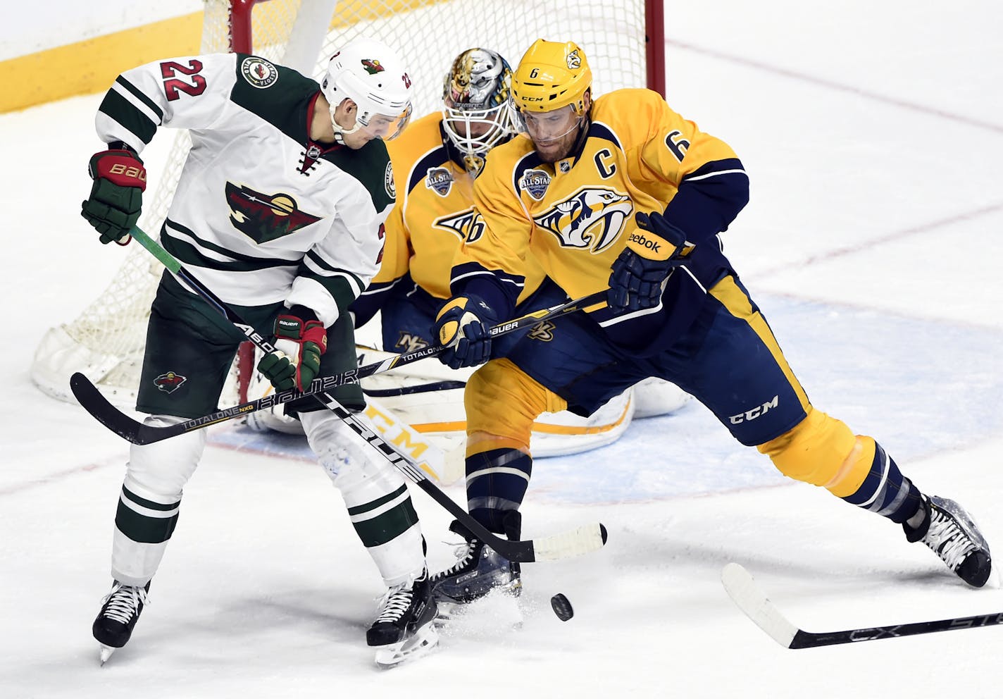 Minnesota Wild right wing Nino Niederreiter (22), of Switzerland, is defended by Nashville Predators defenseman Shea Weber (6) in the third period of an NHL hockey game Saturday, Jan. 16, 2016, in Nashville, Tenn. The Predators won 3-0. (AP Photo/Mark Zaleski)