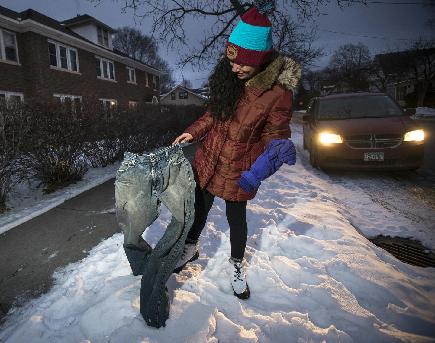 Melissa Valladares, visiting from El Salvador for an internship, investigated a pair of frozen blue jeans on display at the intersection of 2nd Street and 16th Avenue NE. The jeans were put out by Randall Johnson, of Minneapolis, a former student of MCAD.