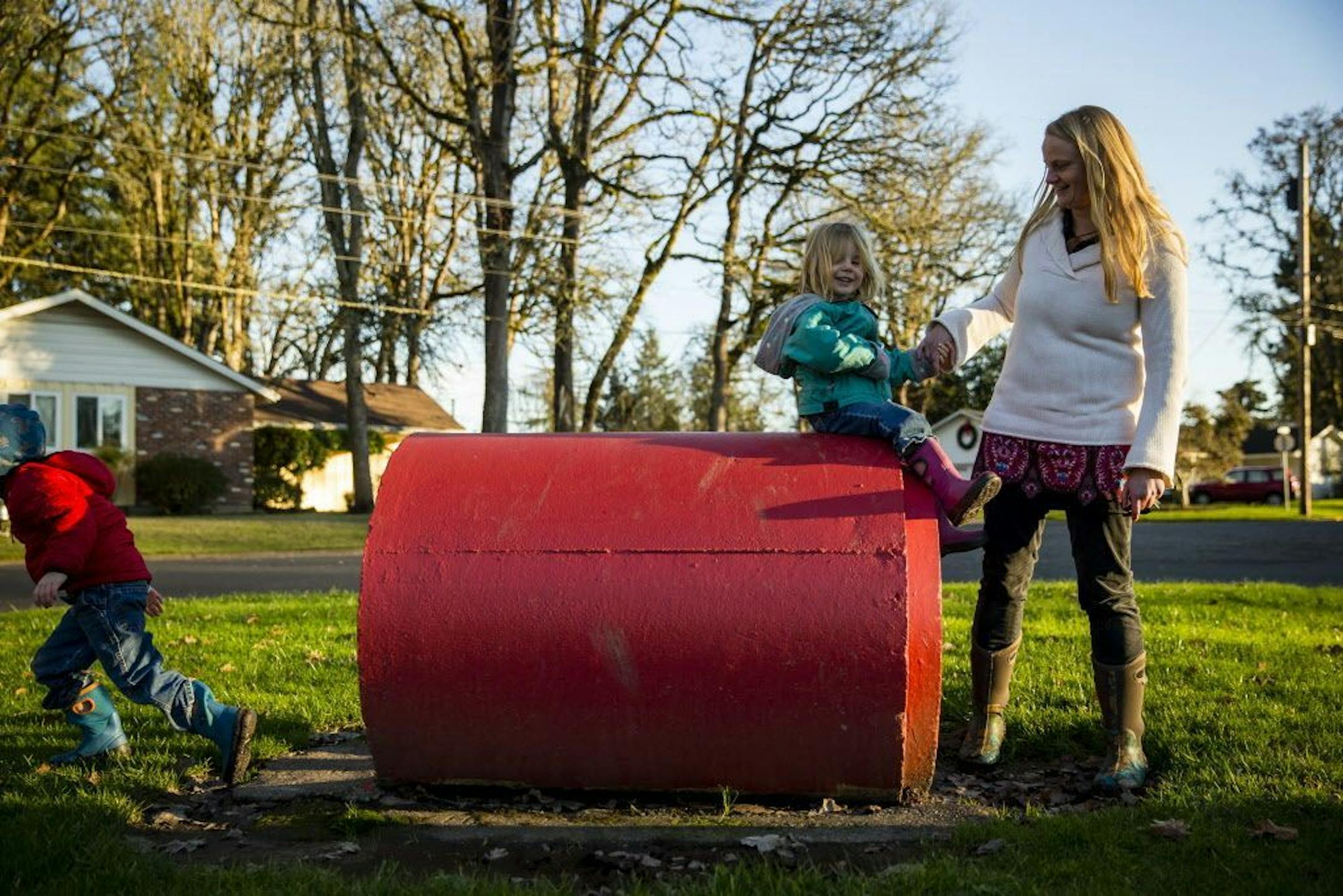 Erin Dietrich plays with her children Zavier, 4, right, and Sahalie, 3, at a park in Monmouth, Ore. Dec. 30, 2015. Dietrich says an untreated tear from Zavier�s home delivery led to long-term complications and prompted her to have Sahalie in a hospital, where she missed the individual attention of alternative birth but was thankful for medical intervention when she had another tear.