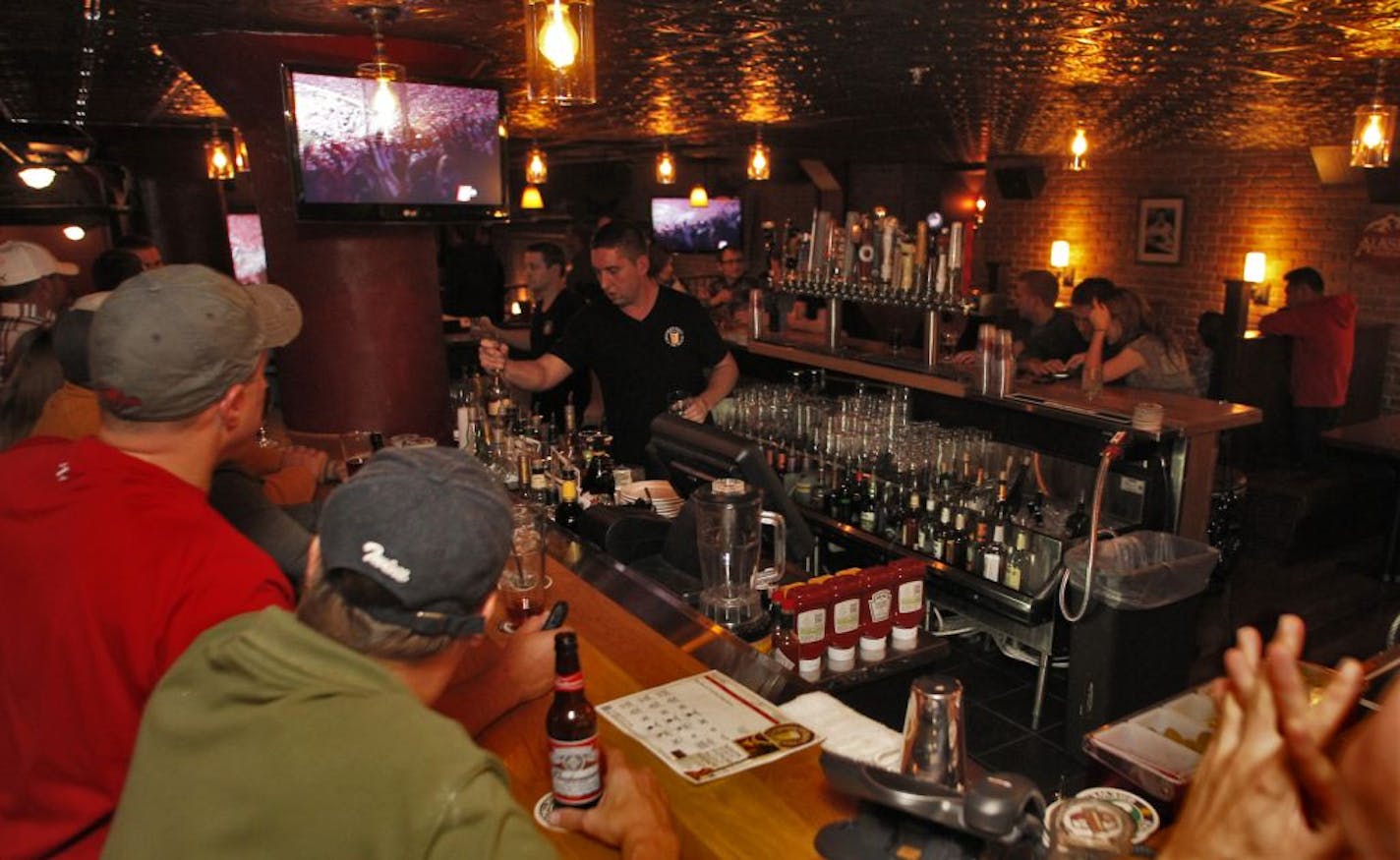 The Crooked Pint Ale House in Minneapolis recently completed a remodeling resulting in a two tier customer space and a central bar. The band, Hookers and Blow played to a crowd on a recent night. The new central bar area.