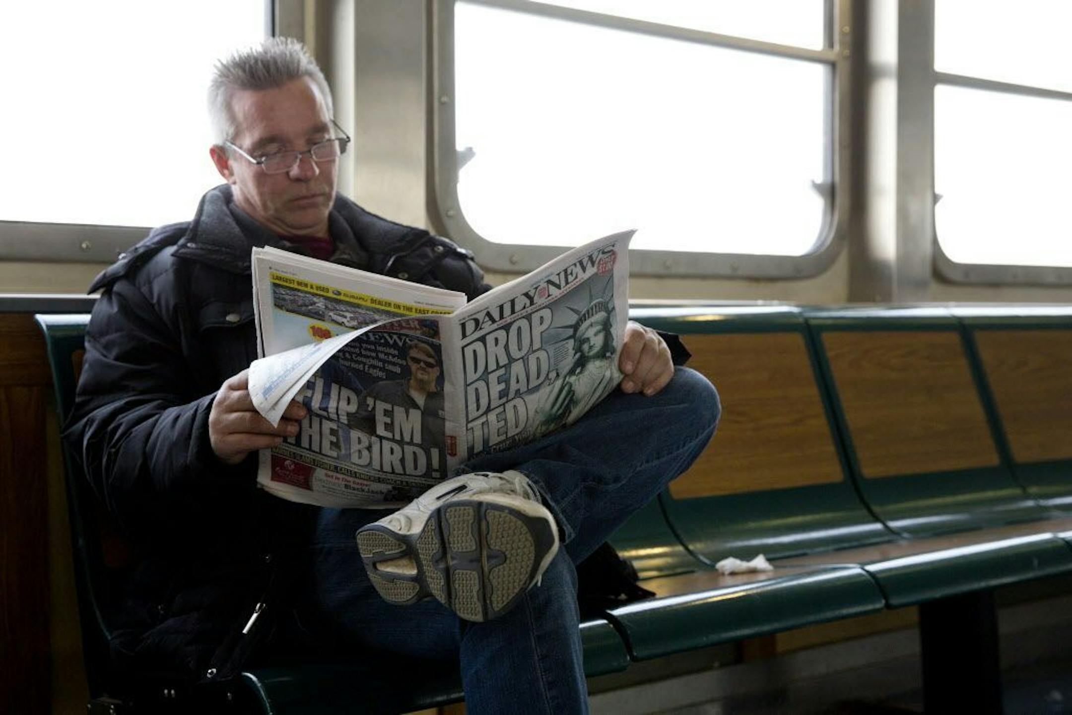 Staten Island resident James Mulvaney reads the New York Daily News, Friday, Jan. 15, 2016, in New York, with the newspaper's front and back page headlines in response to Republican presidential candidate Ted Cruz.