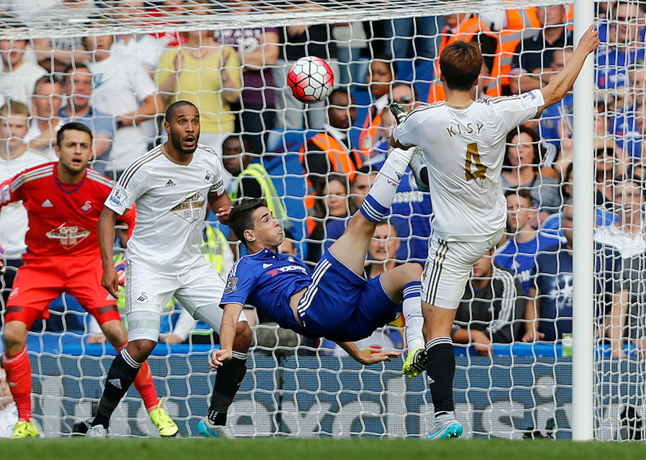 Chelsea's Oscar, center, kicks the ball during the English Premier League soccer match between Chelsea and Swansea City at Stamford Bridge stadium in London, Saturday, Aug. 8, 2015.
