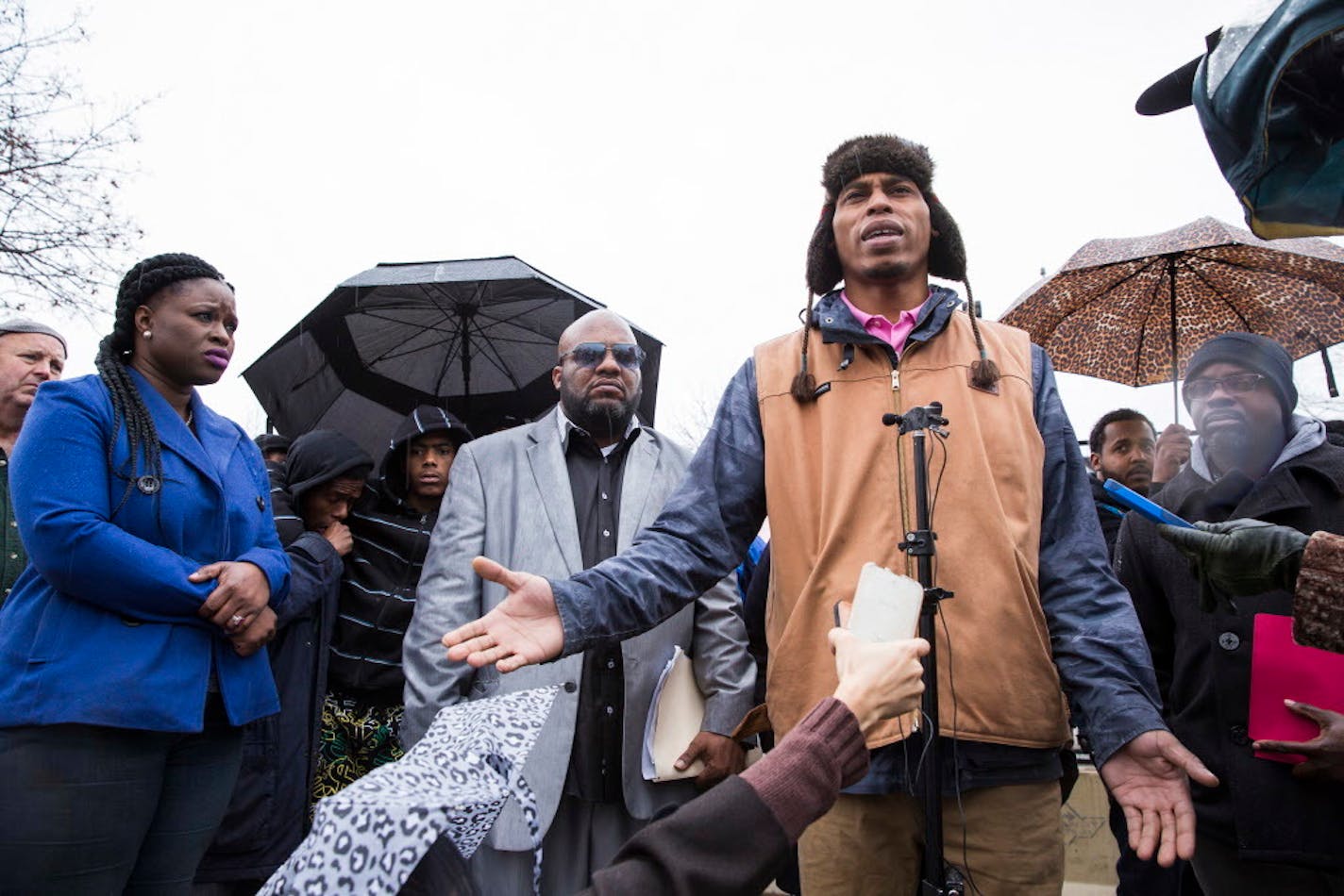 Cameron Clark, one of the five shooting victims from outside the Fourth Precinct and cousin of Jamar Clark, speaks to the media during a press conference outside the Fourth Precinct police station in Minneapolis on December 8, 2015.