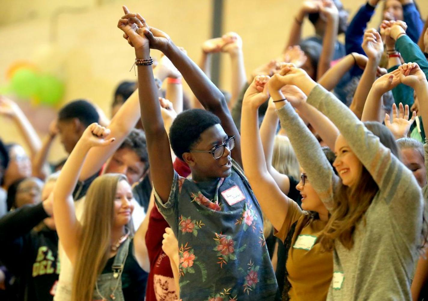 Como Park Senior High teachers and upper class students welcomed new students at a freshman orientation event Thursday, Aug. 31, 2017, at Como Park High in St. Paul, MN. Here, incoming freshman stretch during a welcoming exercise.