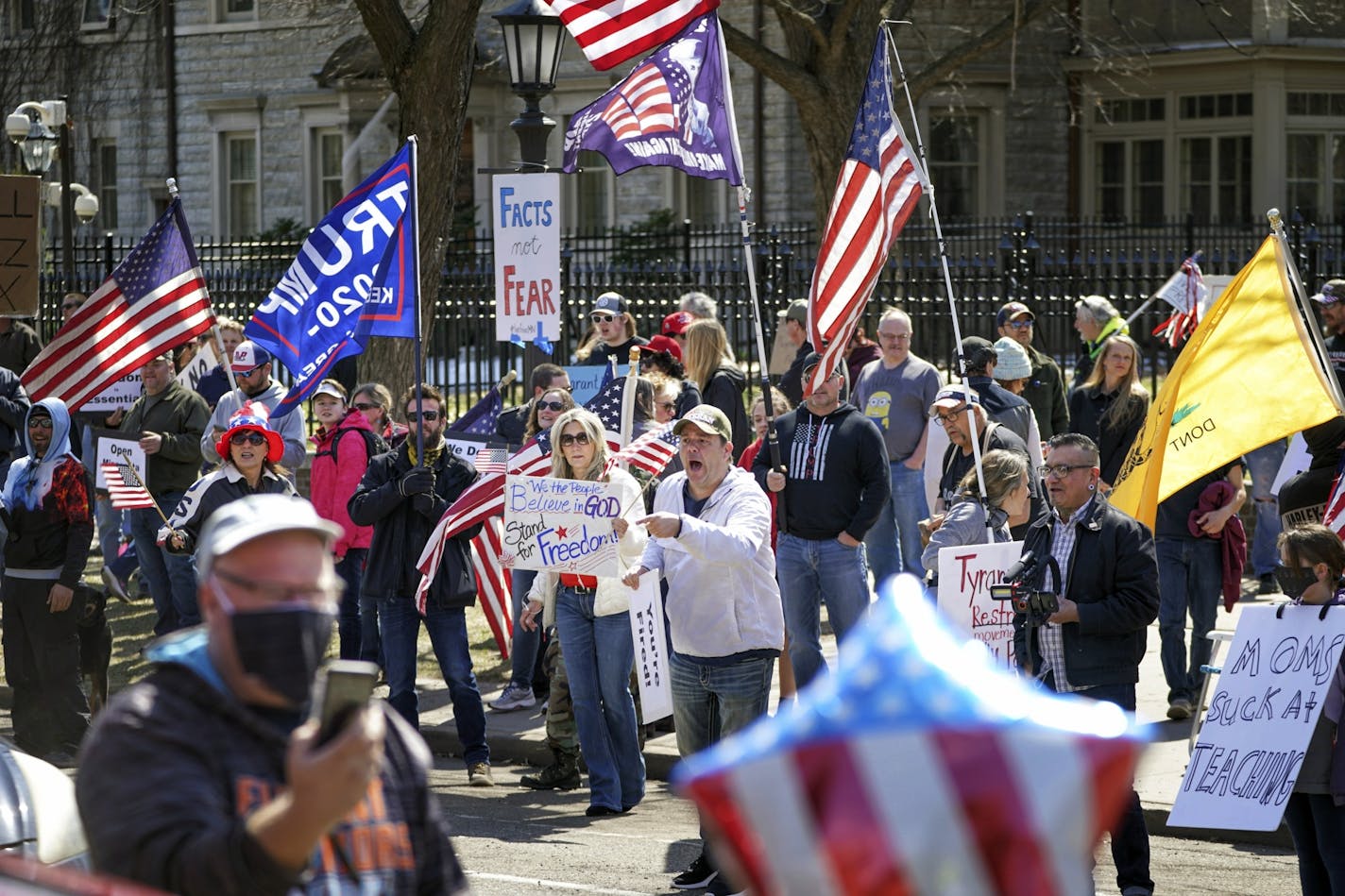 Hundreds of protesters gather outside Minnesota Gov. Tim Walz' official residence, Friday, April 17, 2020 in St. Paul, Minn. President Donald Trump tweeted his support for a protest outside Gov. Tim Walz's official residence in St. Paul against Minnesota's continued stay-at-home order.