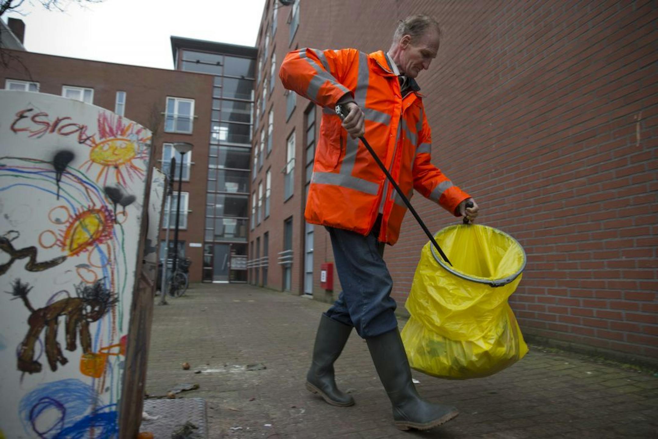 Fred Schiphorst, an alcoholic and former construction worker, sets out on his daily route to collect litter in Amsterdam's eastern part Wednesday Jan. 15, 2014.