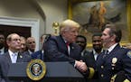 President Donald Trump shakes hands with Chief Paul Cell, of the International Association of Chiefs of Police, during an announcement of his support 