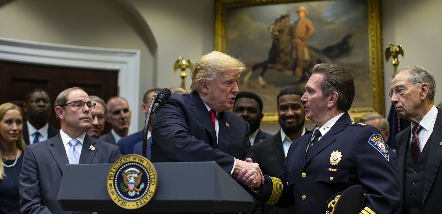 President Donald Trump shakes hands with Chief Paul Cell, of the International Association of Chiefs of Police, during an announcement of his support for a criminal justice reform bill, called the First Step Act, at the White House in Washington, Nov. 14, 2018. Trump threw his support behind the substantial rewrite of the nation&#xed;s prison and sentencing laws Wednesday, and Senators have staked the success of the bipartisan agreement on him. But powerful pockets of opposition remain among som