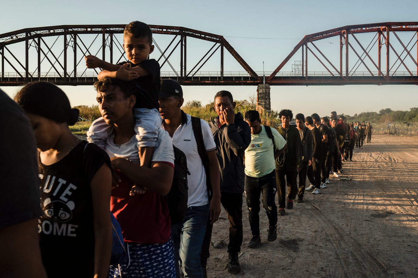 Migrants make their way toward law enforcement personnel to surrender and begin their immigration process, in Eagle Pass, Texas on Sept. 23, 2023.