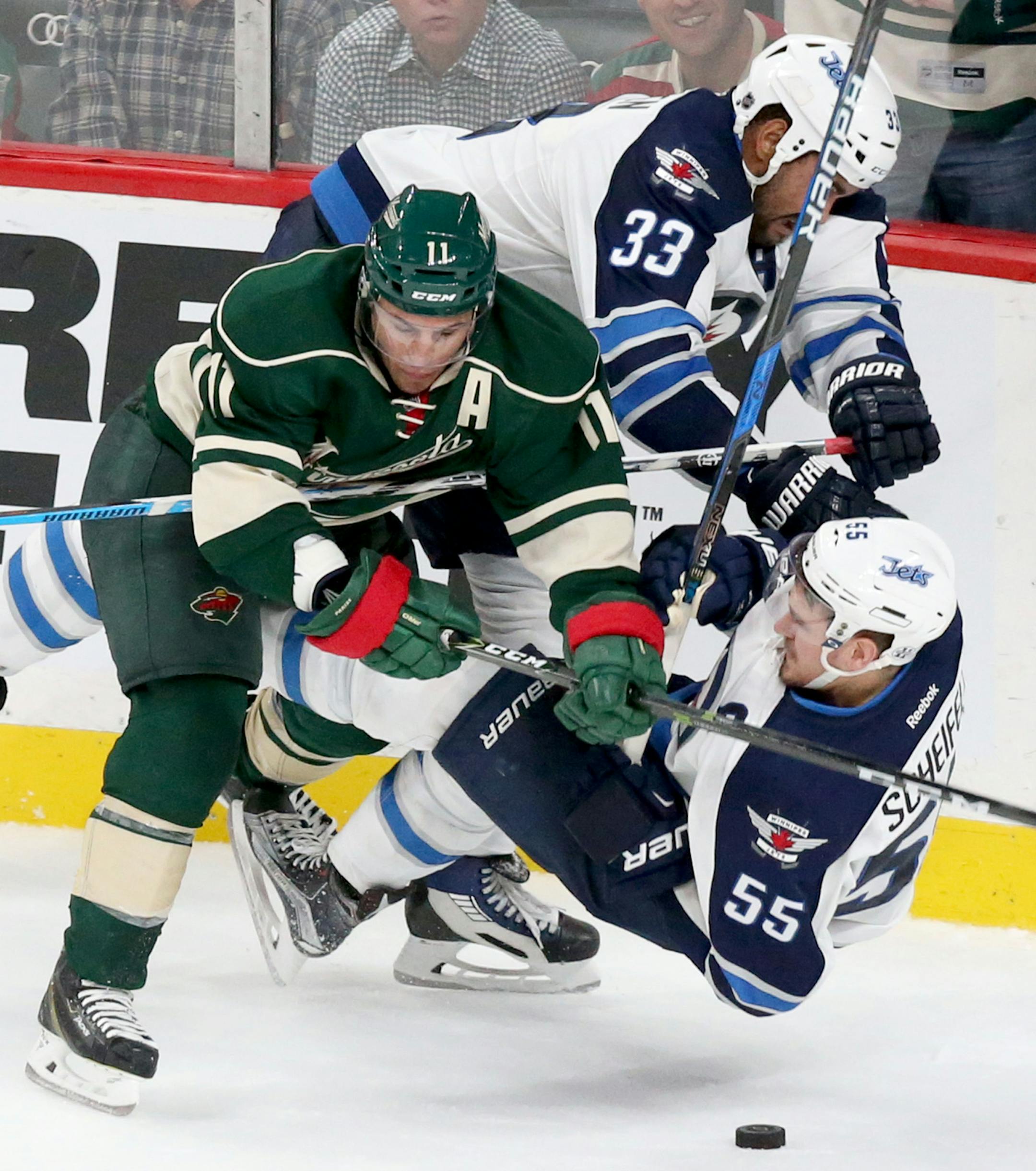 The Minnesota Wild's Zach Parise (11) takes out Winnipeg's Dustin Byfuglien (33) and Mark Scheifele (55) during the third period of the Wild's 4-3 win during the home opener at the Xcel Energy Center Saturday, Oct. 15, 2016, in St. Paul, MN.](DAVID JOLES/STARTRIBUNE)djoles@startribune.comWild season opener vs. Winnipeg at the Xcel Energy Center Saturday, Oct. 15, 2016, in St. Paul, MN.