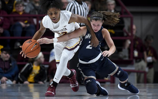 Minnesota Golden Gophers guard Kenisha Bell (23) and New Hampshire Wildcats guard Kari Brekke (2) collided while battling for a loose ball in the seco