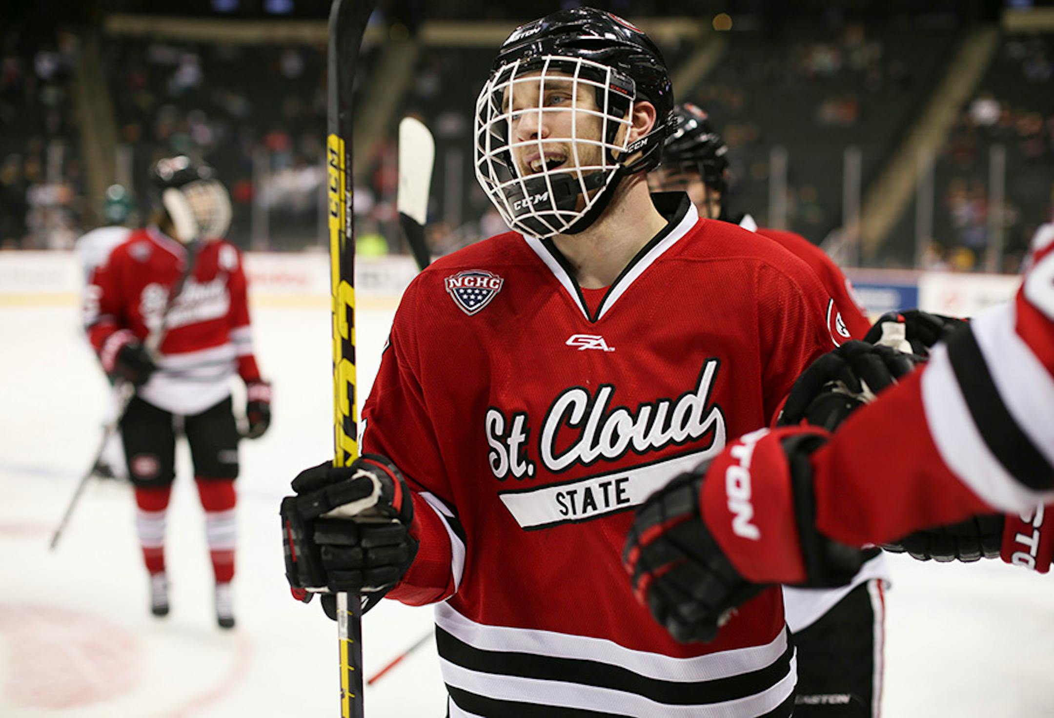 Huskies forward Patrick Russell (63) received congratulations from the St. Cloud bench after he scored in the second period Sunday afternoon.