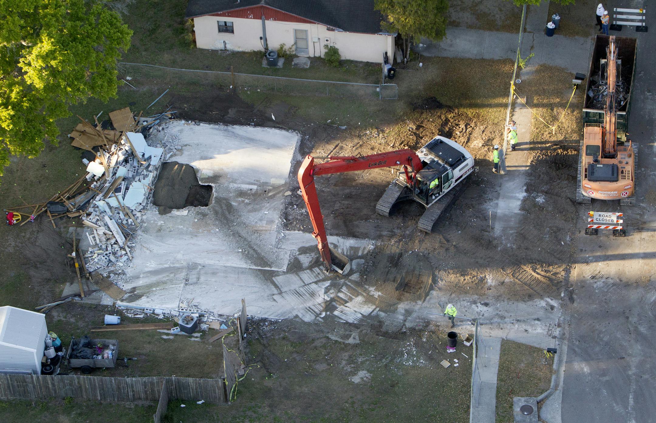 An aerial view of a sinkhole at 240 Faithway Drive in Seffner, Florida that opened up, killing Jeffrey Bush is seen March 4, 2013. The sinkhole is exposed as demolition of the house continues. (Dirk Shadd/Tampa Bay Times/MCT)
