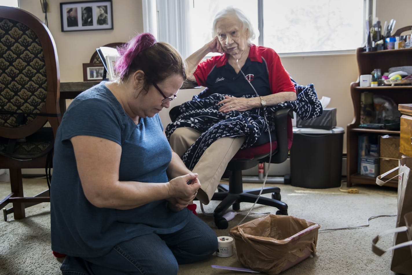 Dawn Lindberg clipped her mother Elsa Lindberg's toenails at home. Dawn lives with her mom in two-week stretches, then goes home to Princeton, Minn., for a weekend.