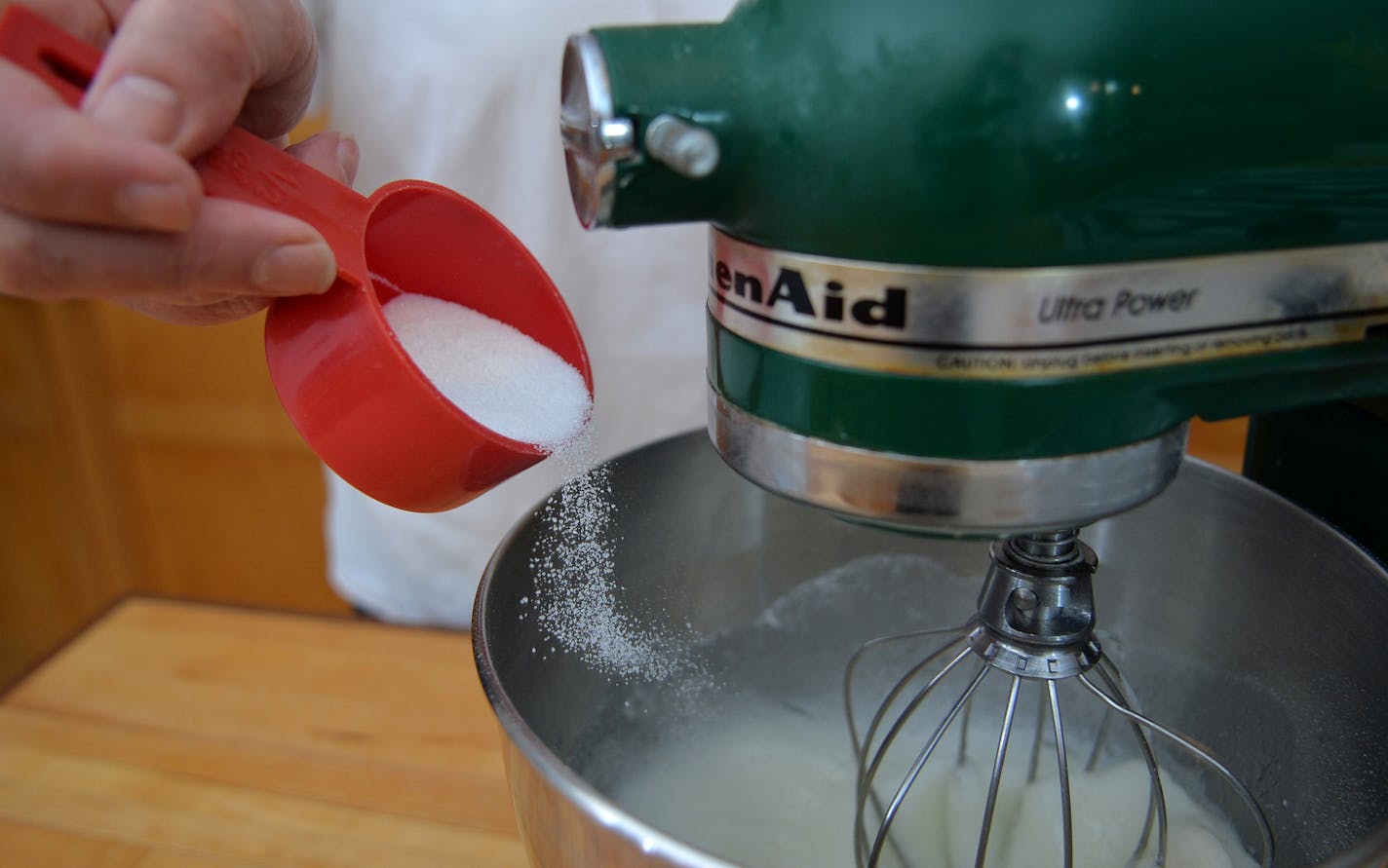 Slowly add the sugar to the egg whites while mixing. ] (SPECIAL TO THE STAR TRIBUNE/BRE McGEE). ]