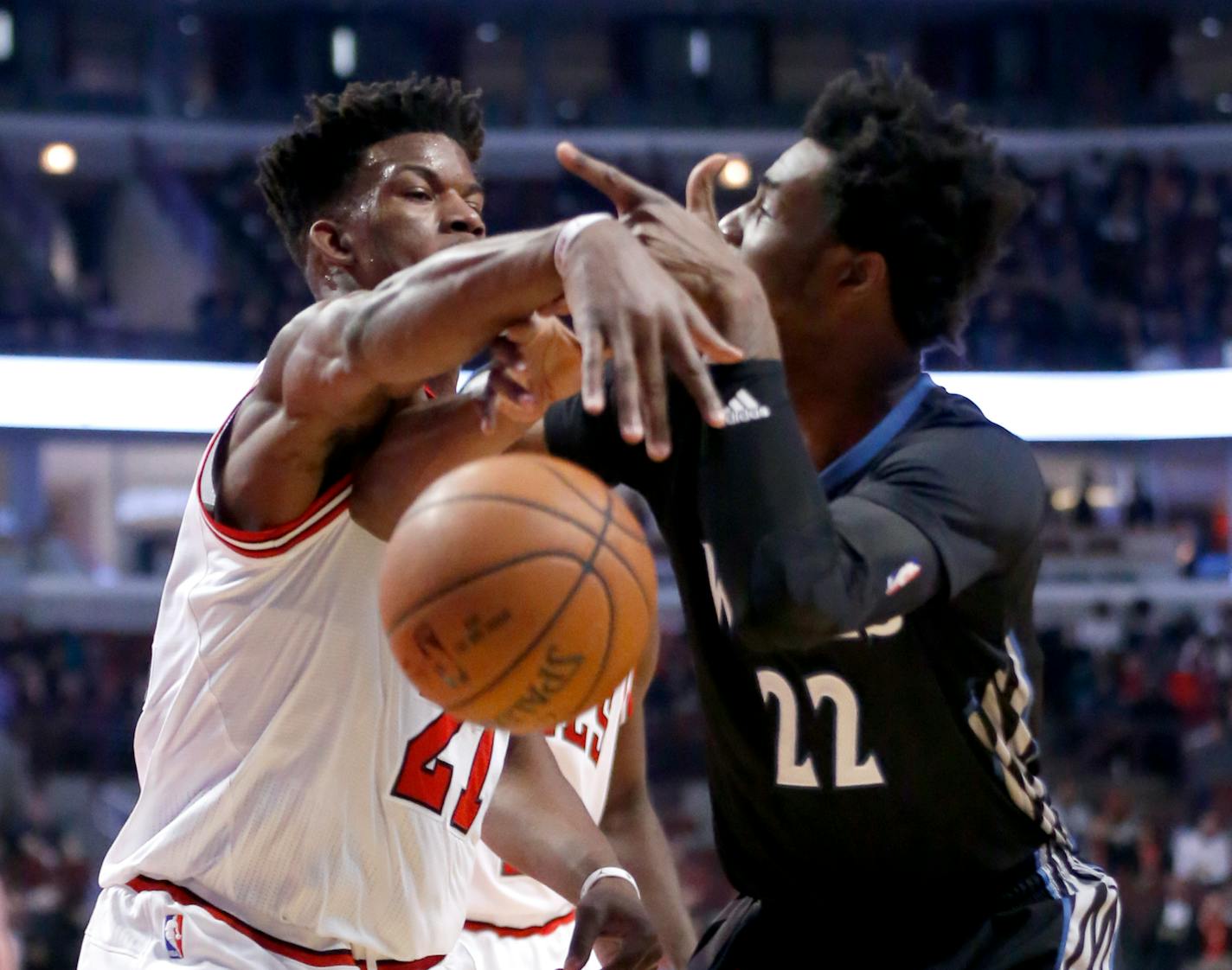 Chicago Bulls' Jimmy Butler, left, slaps the ball out of Minnesota Timberwolves' Andrew Wiggins' hands during the first half of an NBA basketball game, Tuesday, Dec. 13, 2016, in Chicago. (AP Photo/Charles Rex Arbogast)