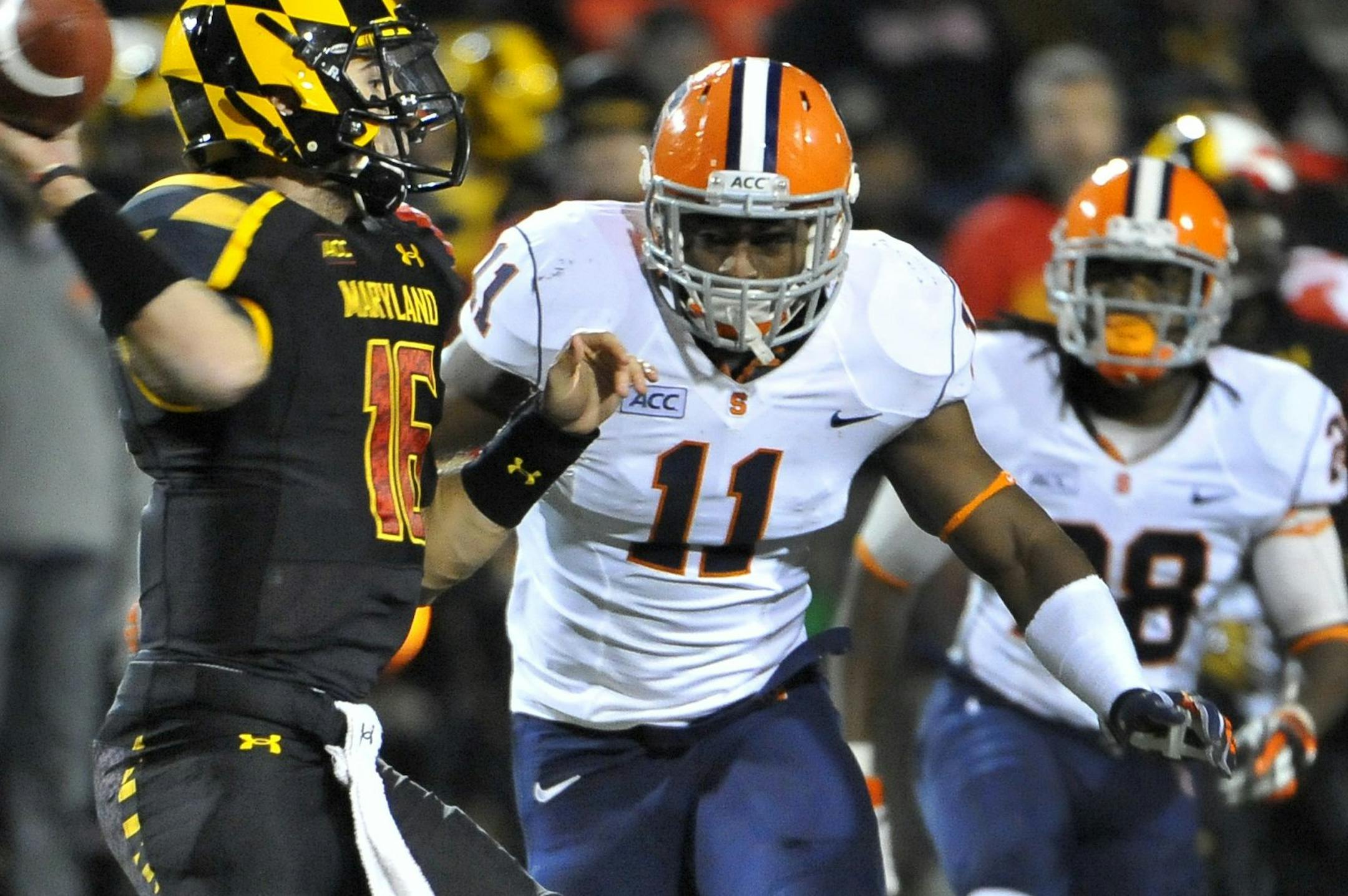 Maryland quarterback C.J. Brown (16) attempts to get a pass off before Marquis Spruill (11) of Syracuse tackles him at Byrd Stadium Saturday, Nov. 9, 2013. Syracuse Orange beat the Maryland Terrapins 20-3. (Mark Gail/MCT) ORG XMIT: 1145381