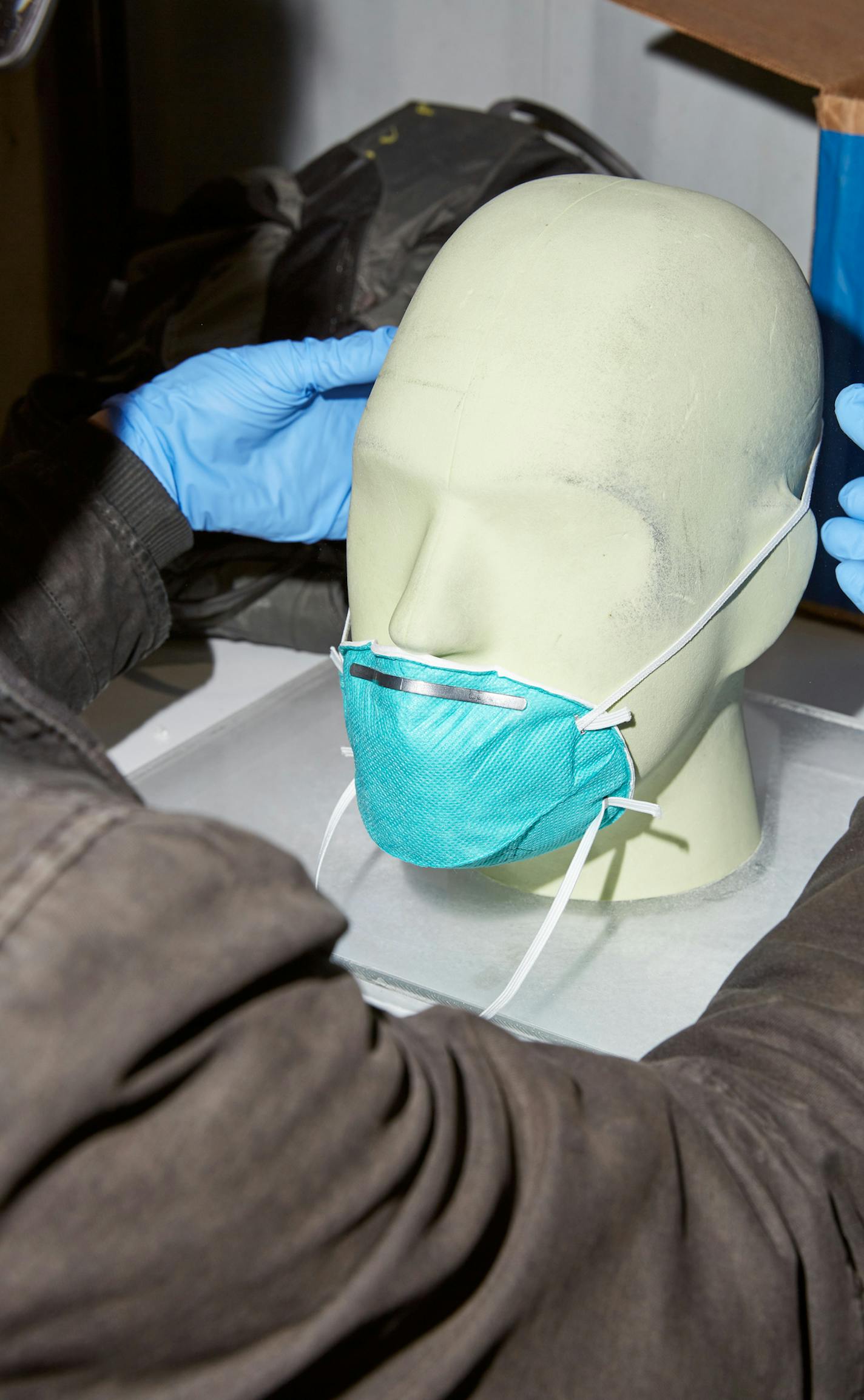 An elastic band of a used mask is inspected at Batelle in Columbus, Ohio on April 2, 2020. Under a sprawling tent in a parking lot near the small town of West Jefferson, employees of Battelle, a nonprofit research and development firm, have spent the recent weeks decontaminating over 30,000 used face masks for doctors and nurses on the front lines of the coronavirus pandemic. (Brian Kaiser/The New York Times)