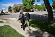 Dr. Ayaz Virji, 42, and his wife Musarrat Virji, 36, walks home from work on a May day in Dawson, Minn. MUST CREDIT: Washington Post photo by Salwan G