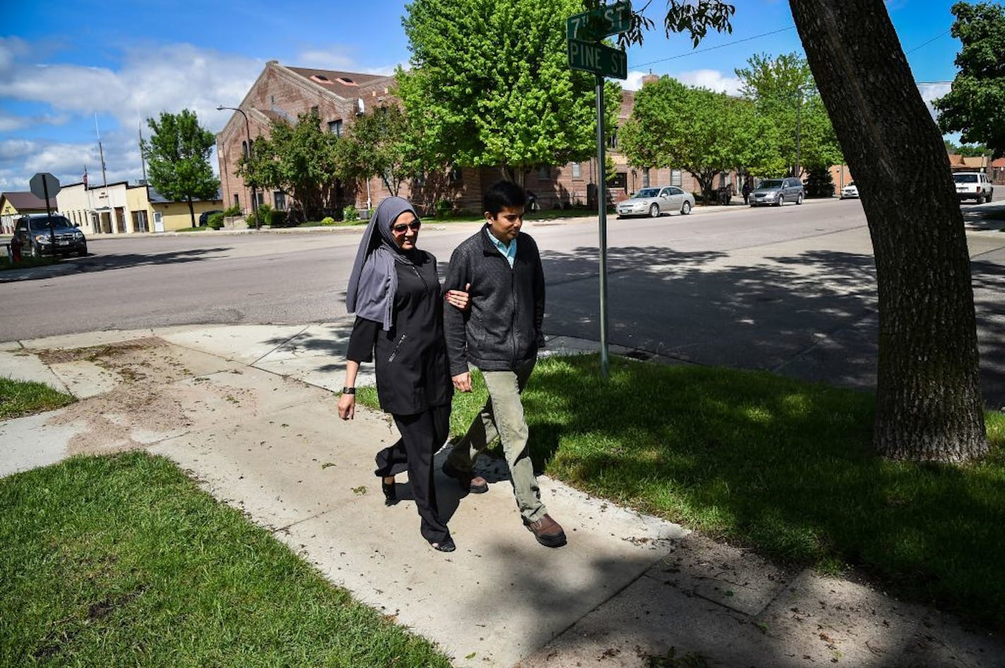 Dr. Ayaz Virji, 42, and his wife Musarrat Virji, 36, walks home from work on a May day in Dawson, Minn. MUST CREDIT: Washington Post photo by Salwan Georges