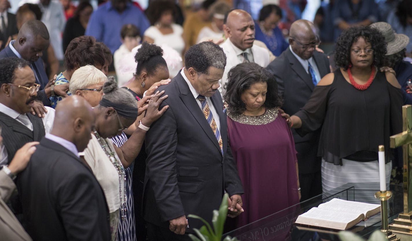 The congregation at Greater Friendship Missionary Baptist Church surrounded the Rev. Billy Russell and his wife, Theresa, as they prayed for strong attendance at this week's National Baptist Convention, which Russell helped bring to Minneapolis.