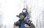 Glenn Simmons Jr. carried his son Kai, 2, atop his shoulders during an outing in Bagley Nature Area in Duluth. The group has met weekly for about thre