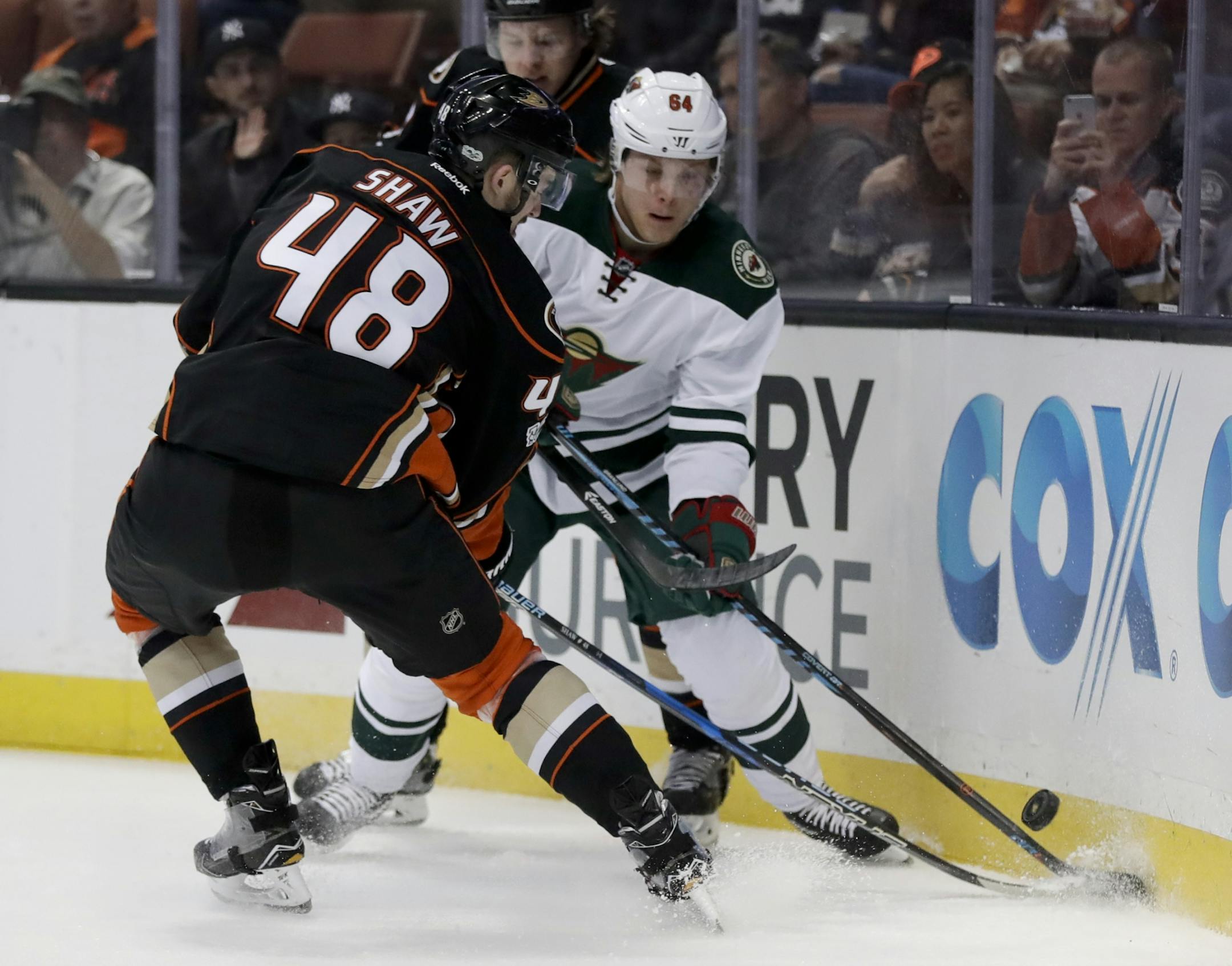 Anaheim Ducks center Logan Shaw, left, left, vies for the with Minnesota Wild center Mikael Granlund during the first period of an NHL hockey game in Anaheim, Calif., Sunday, Jan. 8, 2017.