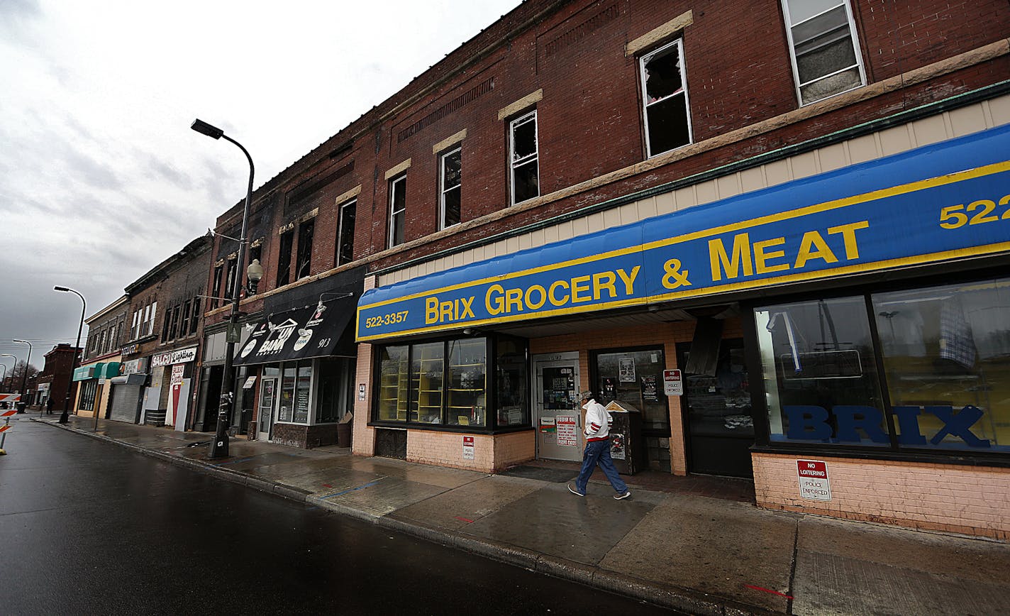 The future of a historic north Minneapolis commercial strip is uncertain more than a week after a blaze ripped through its brick walls. The city said Thursday it won't demolish the properties, leaving building owners to grapple with whether they can be saved. ] JIM GEHRZ &#xef; james.gehrz@startribune.com / Minneapolis, MN / April 24, 2015 /12:00 PM - BACKGROUND INFORMATION: And tenants of the apartments upstairs are still reeling; two of them were hanging out behind the building one recent afte