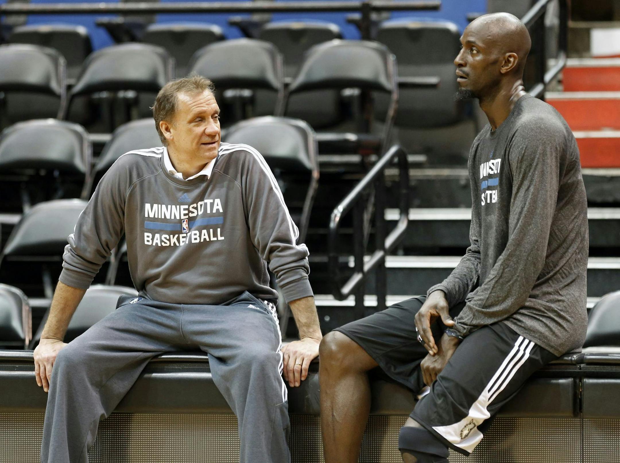 Minnesota Timberwolves star Kevin Garnett, right, talks with head coach Flip Saunders after his first practice upon his return to the former team that originally drafted him out of high school, Tuesday, Feb. 24, 2015, in Minneapolis. Garnett waived his no-trade clause with the Brooklyn Nets to return to Minnesota. (AP Photo/Jim Mone) ORG XMIT: MNJM103