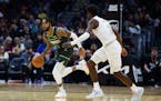 Minnesota Timberwolves guard D'Angelo Russell (0) plays against Cleveland Cavaliers guard Caris LeVert (3) during the second half of an NBA basketball