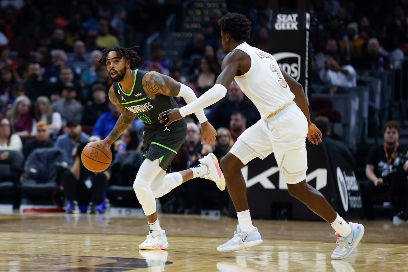 Minnesota Timberwolves guard D'Angelo Russell (0) plays against Cleveland Cavaliers guard Caris LeVert (3) during the second half of an NBA basketball game, Sunday, Nov. 13, 2022, in Cleveland. The Timberwolves won 129-124. (AP Photo/Ron Schwane)