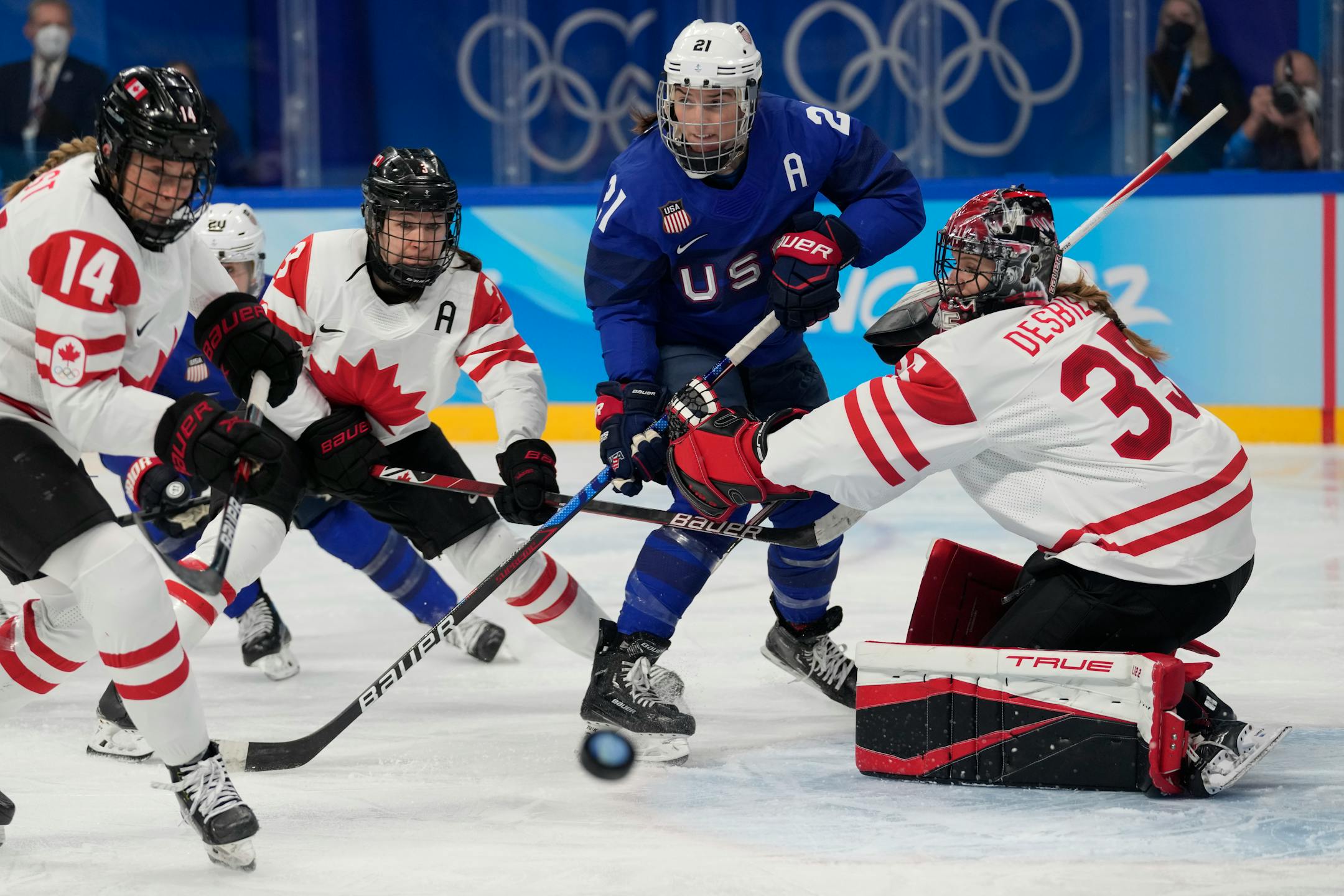 Canada goalkeeper Ann-Renee Desbiens (35) blocks a shot against as United States' Hilary Knight (21) watches for the rebound during a preliminary round women's hockey game at the 2022 Winter Olympics, Tuesday, Feb. 8, 2022, in Beijing. (AP Photo/Petr David Josek)