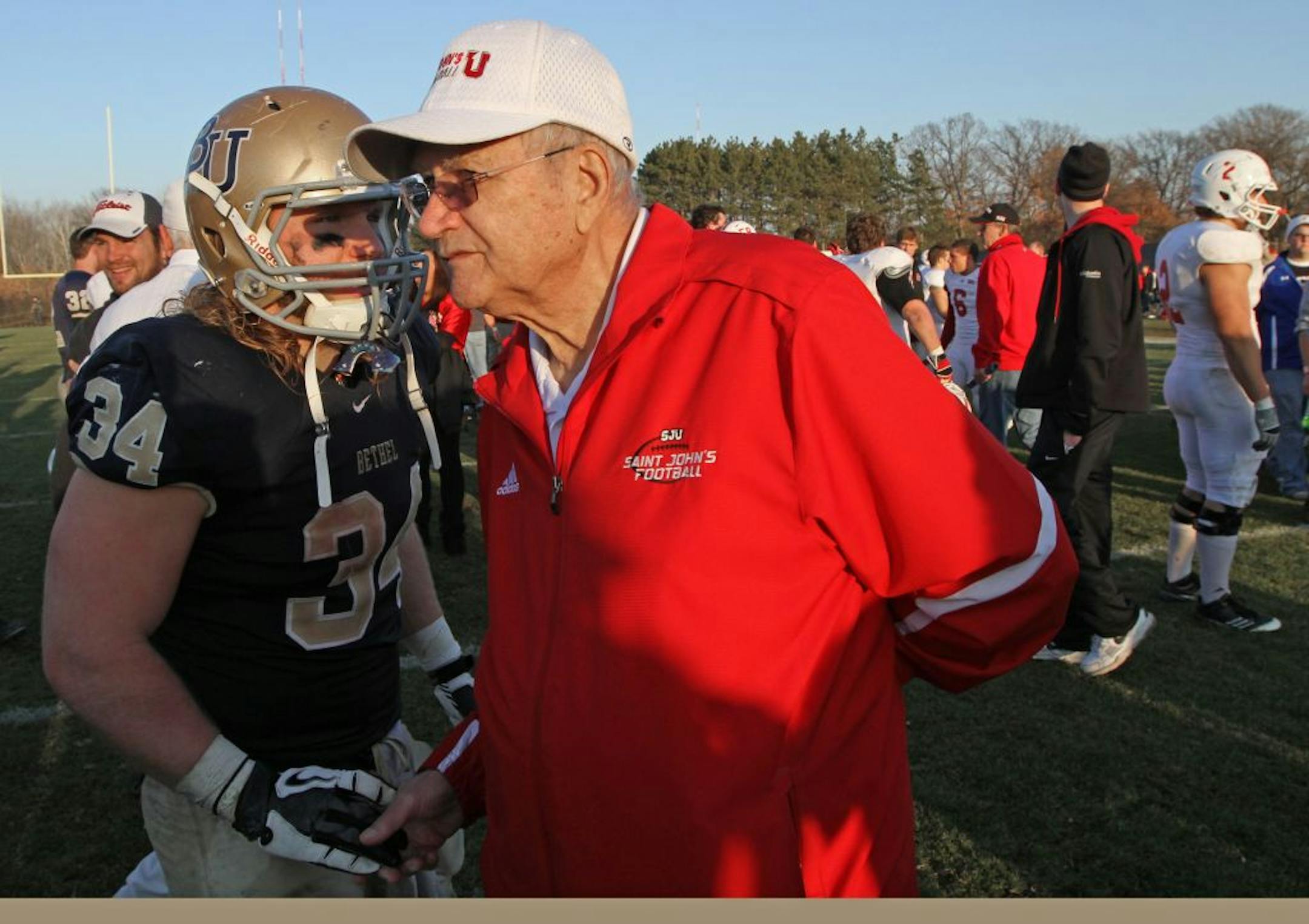 Bethel running back Jesse Phenow talked with St. John's head coach John Gagliardi at the end of the game.