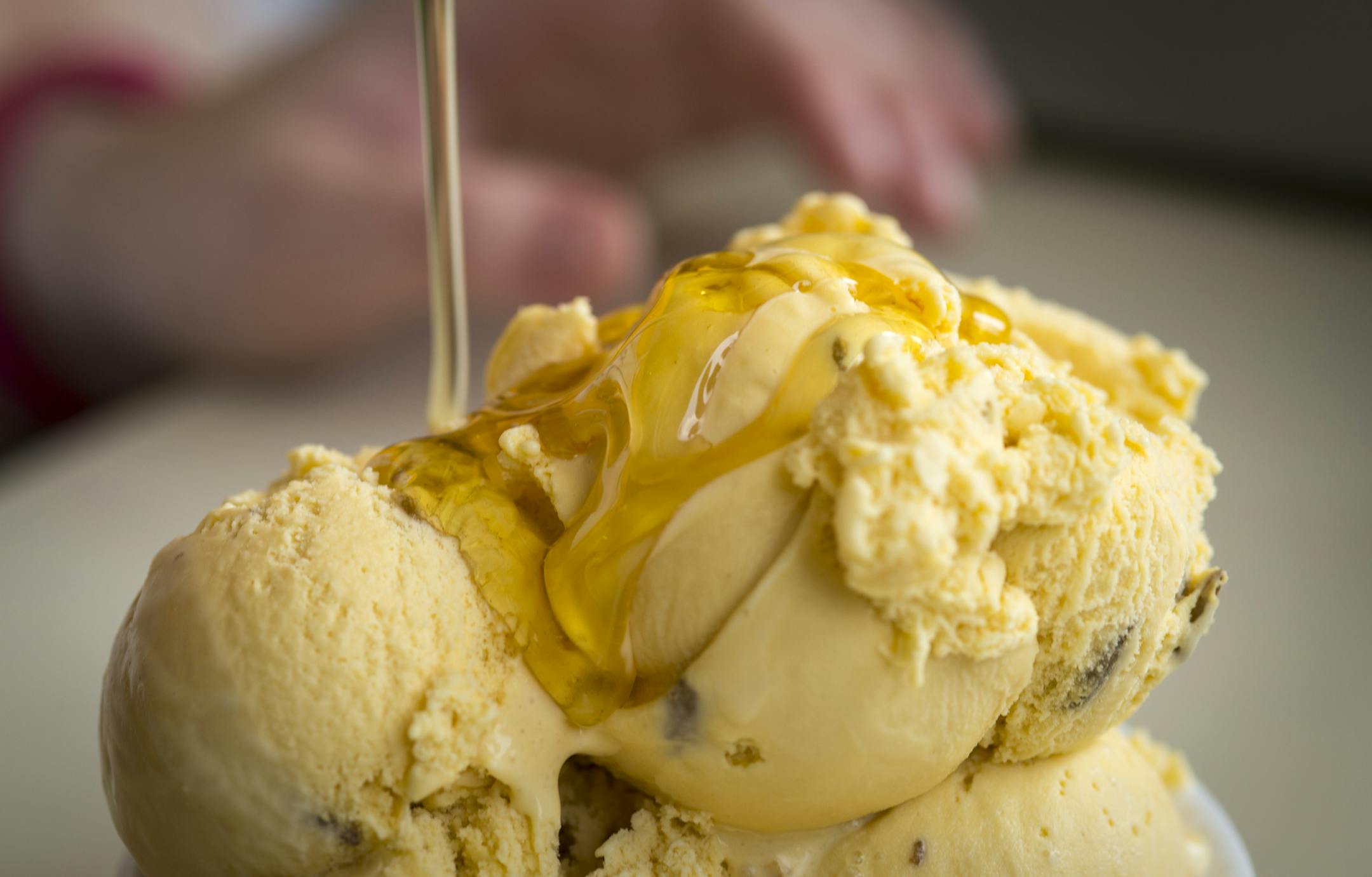 Honey is drizzled onto honey sunflower ice cream as the crowning touch on a sundae at Minnesota Honey Producers.