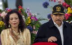 Nicaraguan President Daniel Ortega (C) delivers a speech next to Nicaraguan First Lady Rosario Murillo (L) and Chief Commander of Nicaragua Army Gener