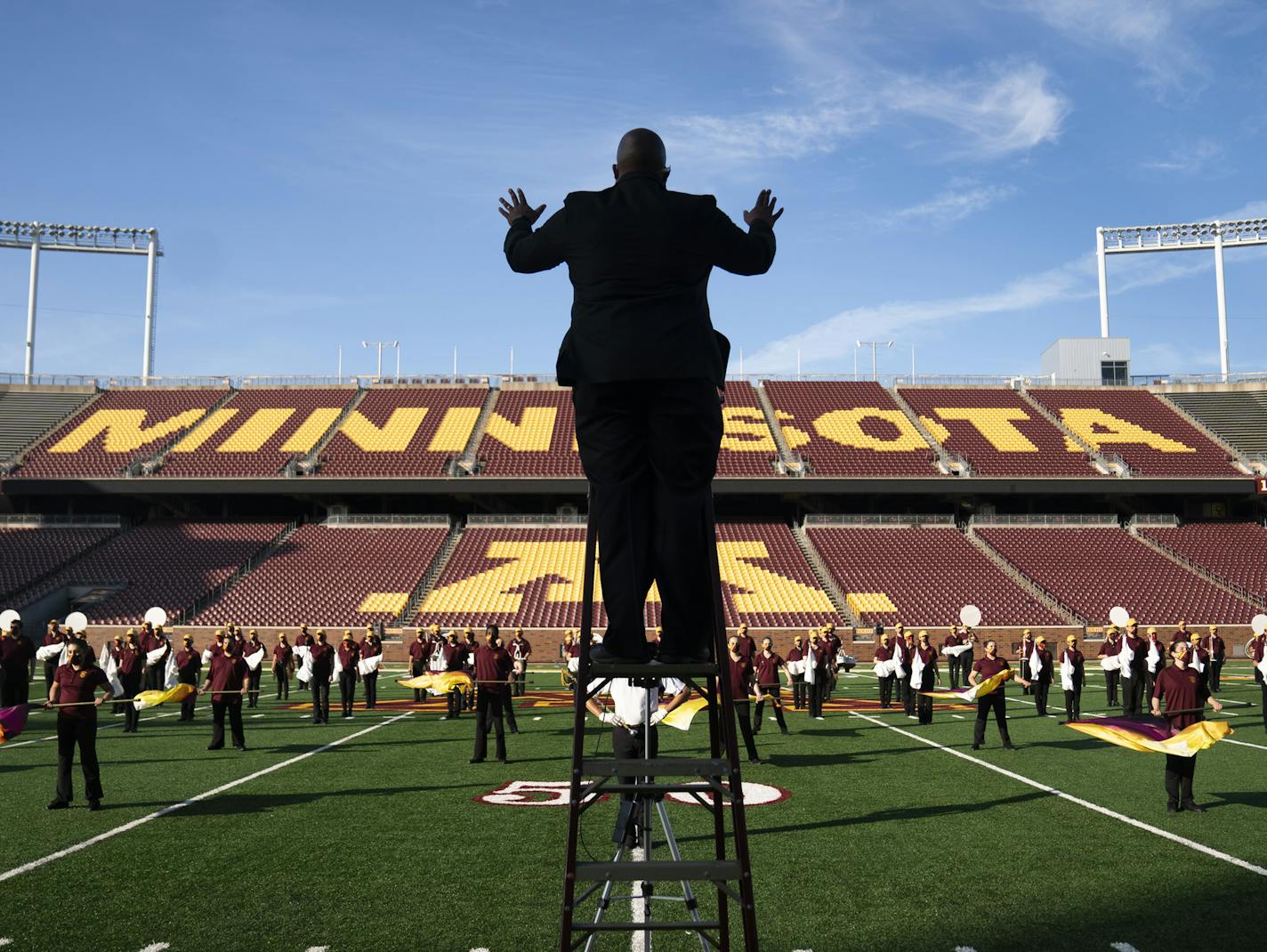 Assistant director Lance Sample conducted the marching band performing at TCF Bank Stadium. The show will be aired on YouTube and Facebook.