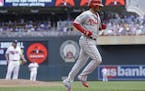 Philadelphia Phillies� Freddy Galvis jogs home on his three-run home run off Minnesota Twins pitcher Kevin Jepsen, background left, in the eighth in