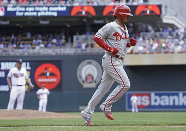 Philadelphia Phillies� Freddy Galvis jogs home on his three-run home run off Minnesota Twins pitcher Kevin Jepsen, background left, in the eighth in