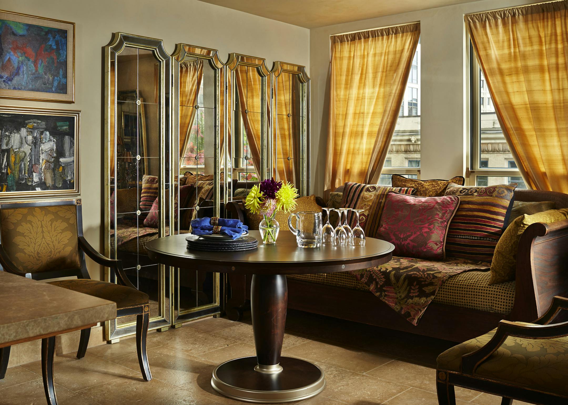 The daybed came from a garage sale; it's used for dining room seating and, when their daughter visits, for sleeping. Vickie loves the thrill of the hunt for interiors via consignment stores or garage and estate sales. The table is from Modele's. (Benjamin Benschneider/Seattle Times/TNS) ORG XMIT: 1161558