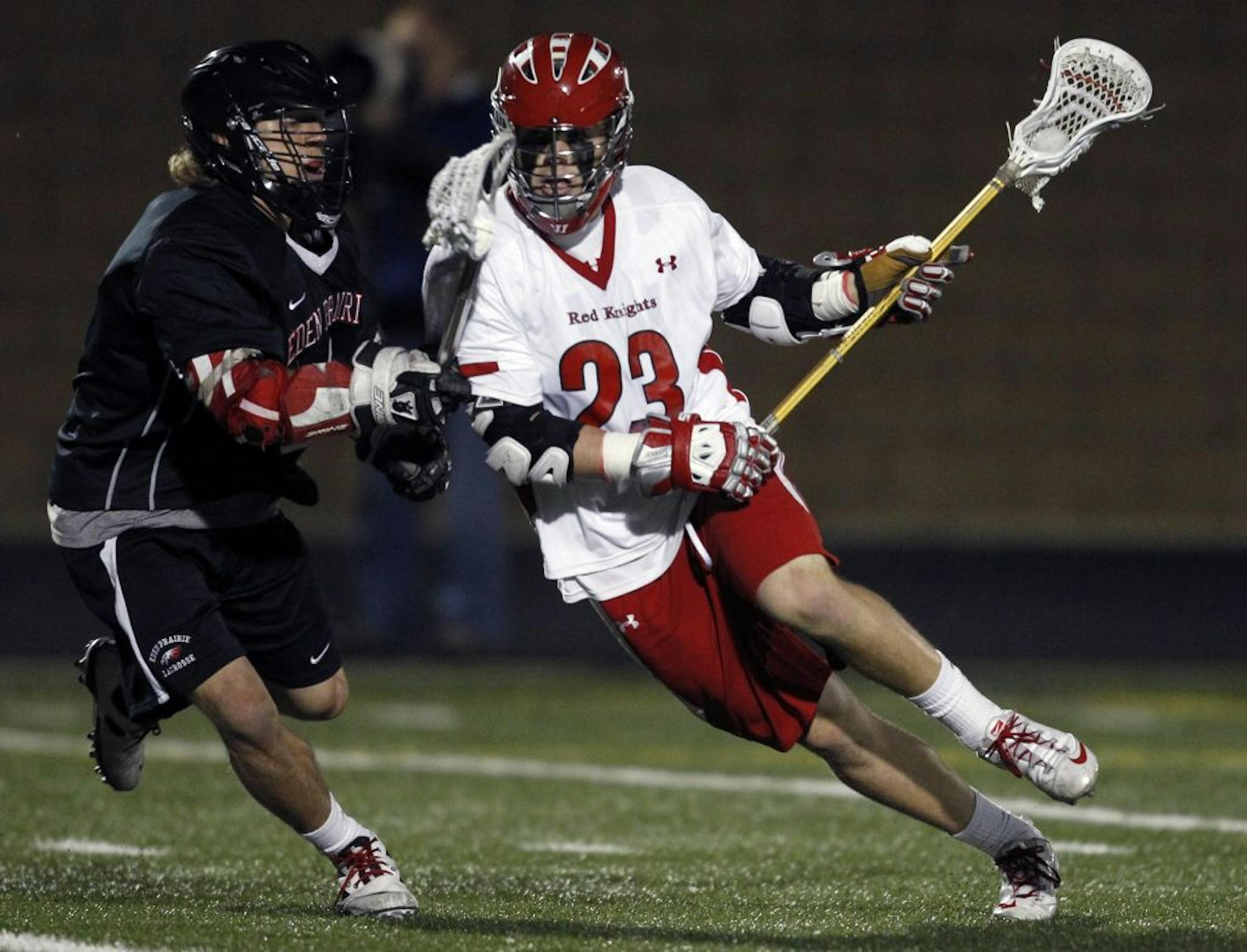 At Chanhassen H.S. in the state lacrosse finals between B.S.M. and Eden Prairie, Taylor Topousis(23) of B.S.M. gets a ball past Riley Boehm(4) making the lead 7-2 for Benilde.