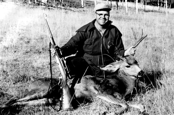 October 23, 1960: Jim Peterson Displays a buck mule deer that the Minneapolis Tribune outdoors writer bagged while hunting north of Livingston, Mont. 