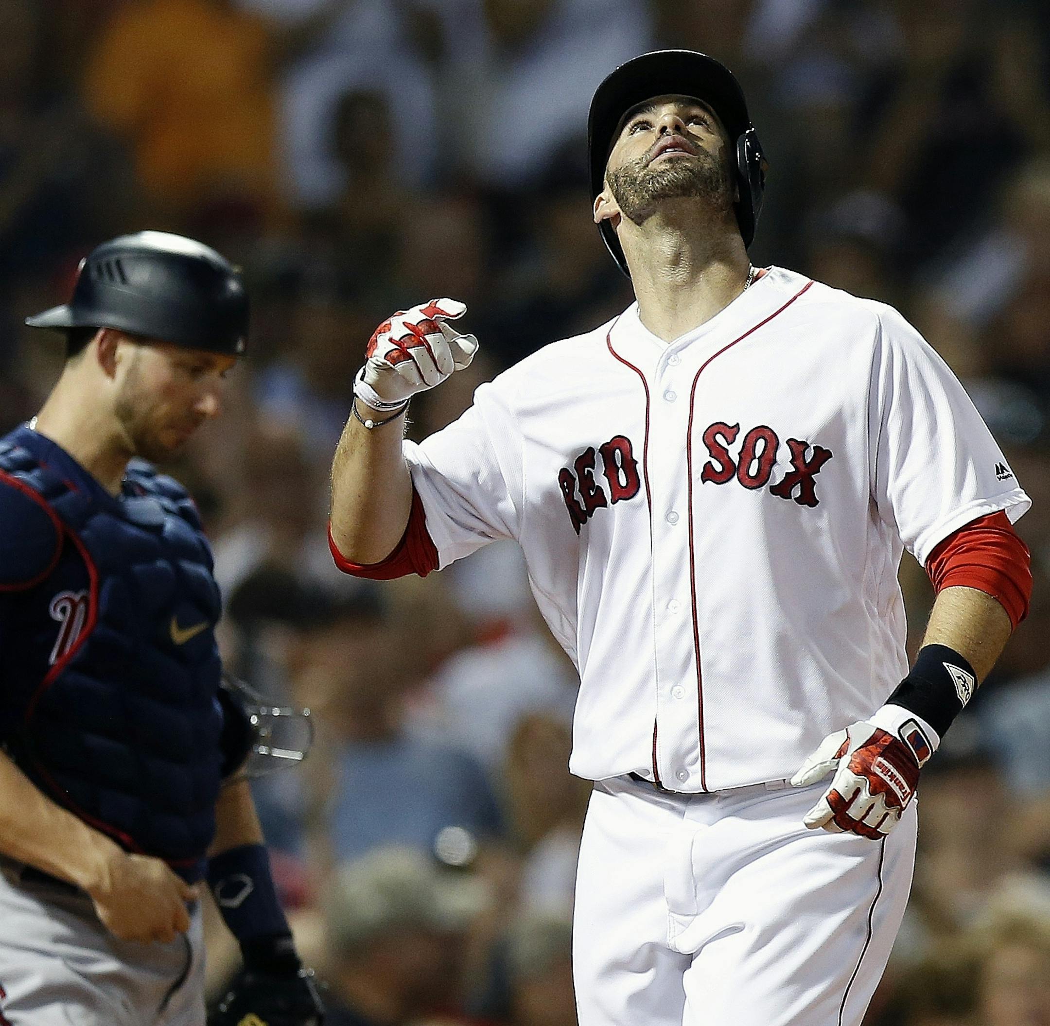 Boston Red Sox's J.D. Martinez, right, celebrates his solo home run beside Minnesota Twins' Mitch Garver during the fifth inning of a baseball game in Boston, Saturday, July 28, 2018. (AP Photo/Michael Dwyer)