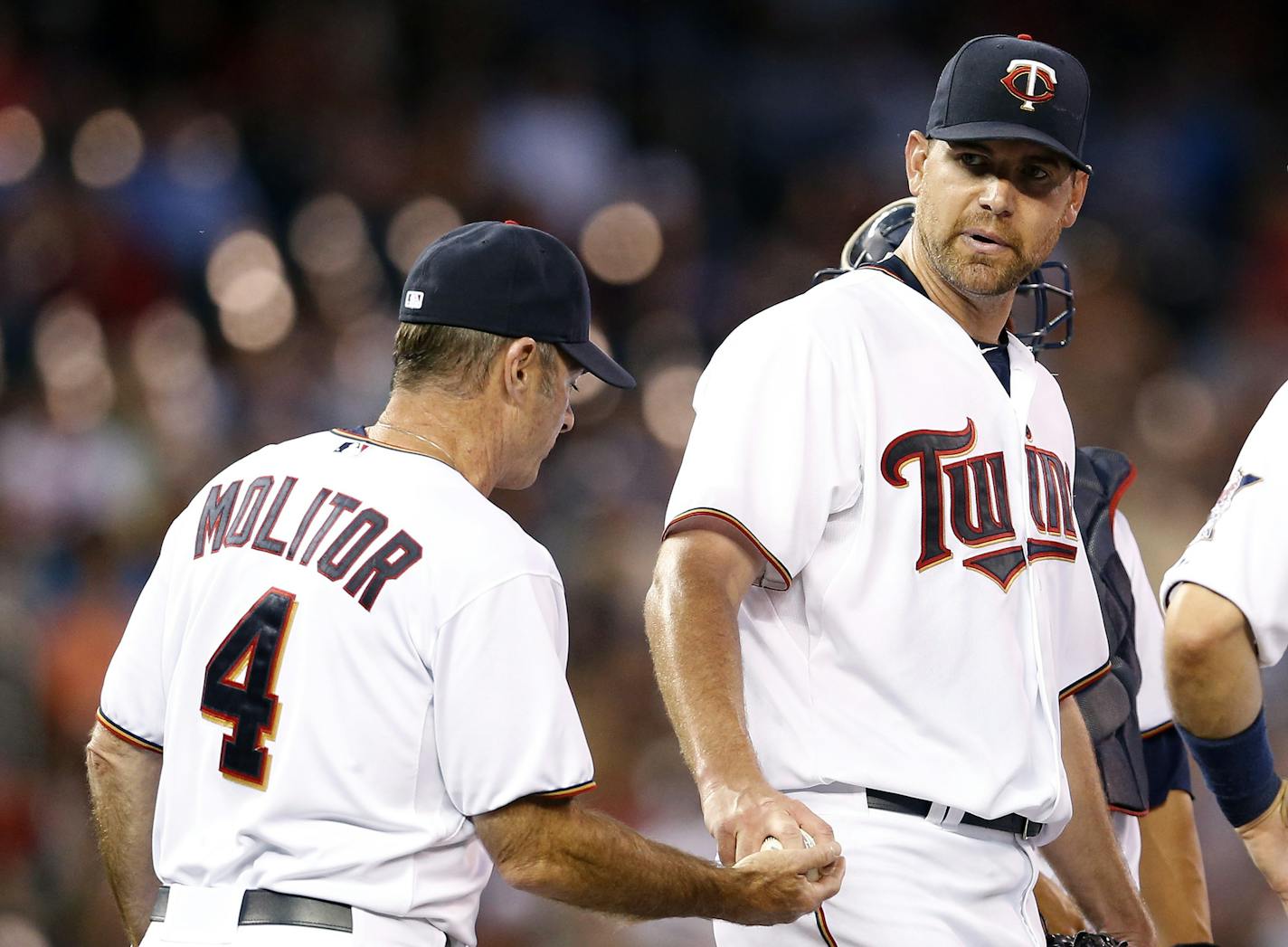 Minnesota Twins starting pitcher Mike Pelfrey (37) handed the ball to Manager Paul Molitor after being pulled out of the game in the seventh inning.