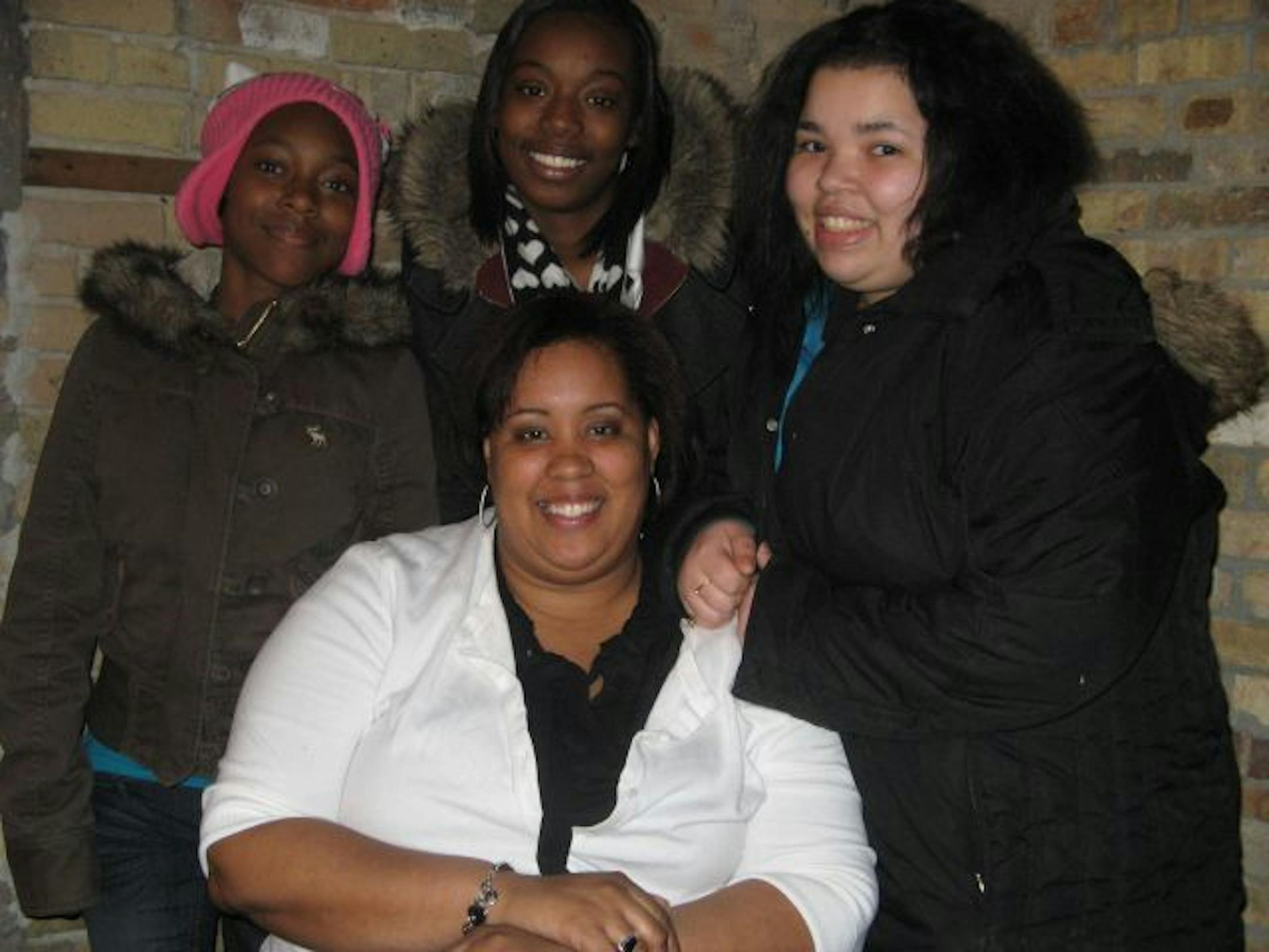 Project Diva volunteer mentor Patrice Cox, who works for RBC Financial, surrounded by her charges: Decaria Rodgers, 12; Jasmin Clark, 17; and Olivia Martin, 15, meet at least weekly to discuss school, explore issues of personal responsibility, volunteer and prepare for college. Photo: Neal St. Anthony- Star Tribune