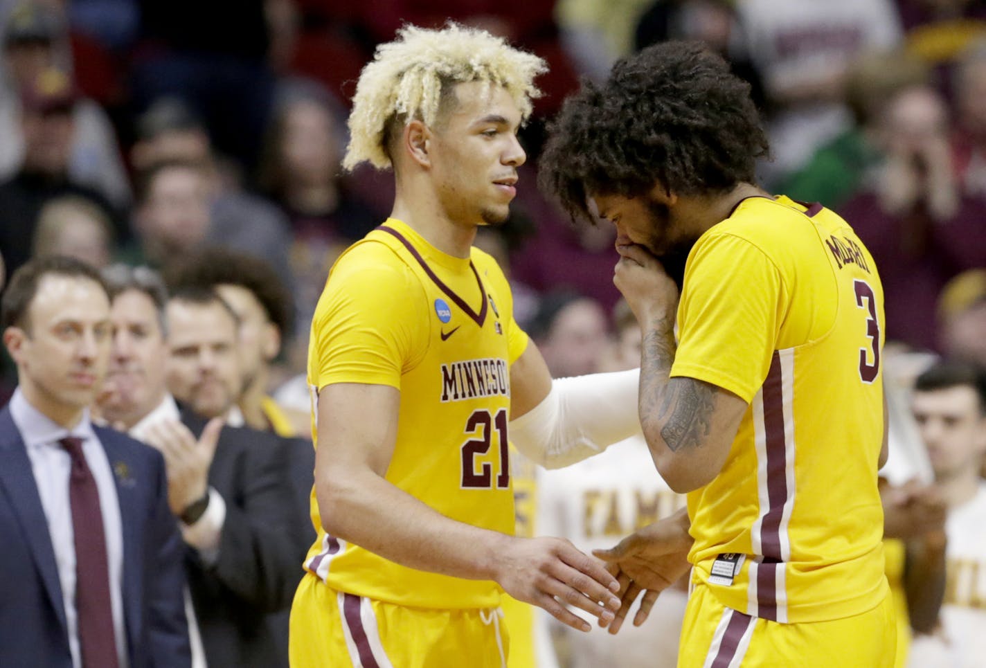 Minnesota's Jarvis Omersa (21) comforts Jordan Murphy (3) as the second half of a second round men's college basketball game against Michigan State comes to an end in the NCAA Tournament, in Des Moines, Iowa, Saturday, March 23, 2019. (AP Photo/Nati Harnik)