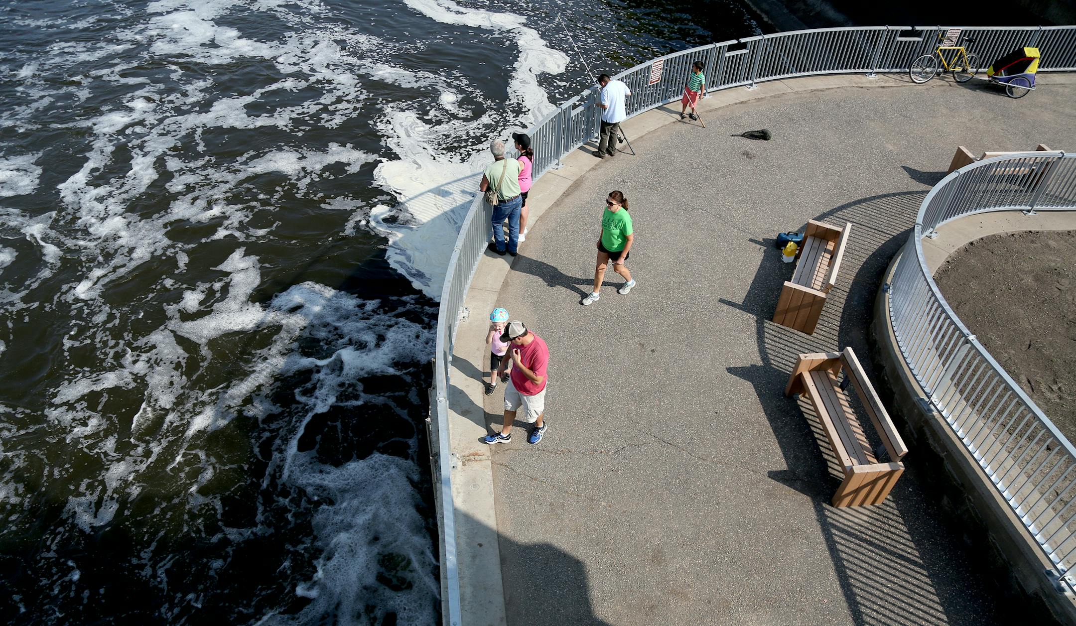 Pedestrians checked out the reopened Coon Rapids Dam viewing areas. Work to shore up the dam and install barriers to invasive carp is 95 percent done.