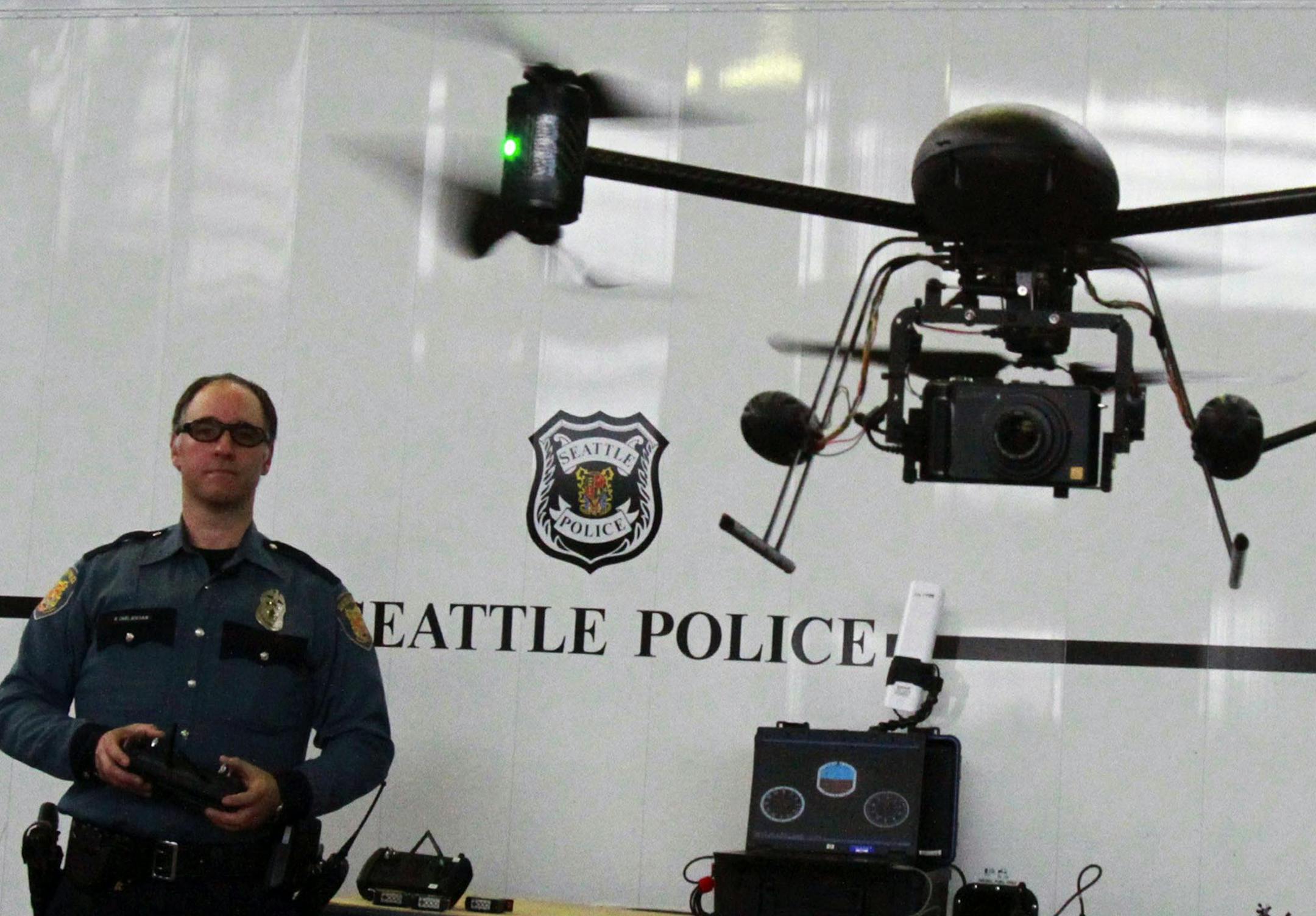 In this April 27, 2012, photo, Seattle Police officer Reuben Omelanchuk is at the controls of the department's new, small radio-controlled Draganflyer X6 drone with a camera attached, in Seattle. The mayor of Seattle is ending the police department's drone program after local residents protested, Thursday, Feb. 7, 2013. (AP Photo/The Seattle Times, Alan Berner) MAGS OUT; NO SALES; SEATTLEPI.COM OUT; MANDATORY CREDIT ORG XMIT: MIN2013021515551103