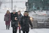 Commuters climbed out of busses and into the snow at the Apple Valley Transit station Monday afternoon. A winter storm was late in coming but hit the Twin Cities hard Monday afternoon.