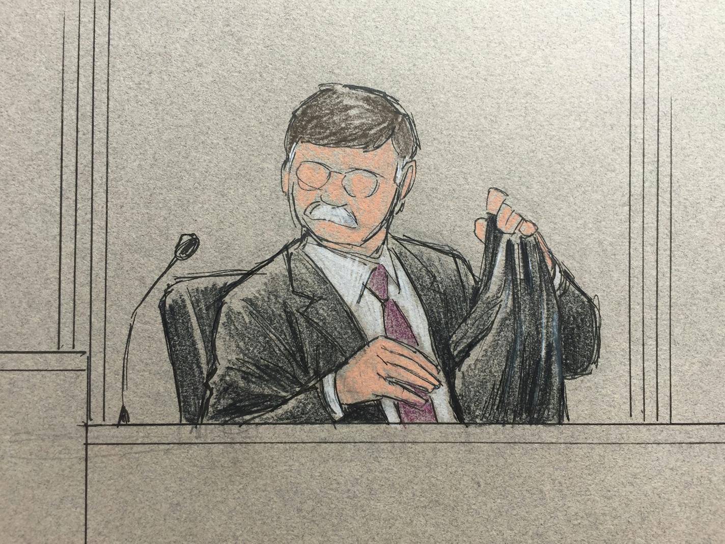 Police firearms and training expert Emanuel Kapelsohn held up a replica of Philando Castile's shorts with a gun in the pocket. (In this sketch, Kapelsohn's face is obscured, in compliance with a judicial order.)