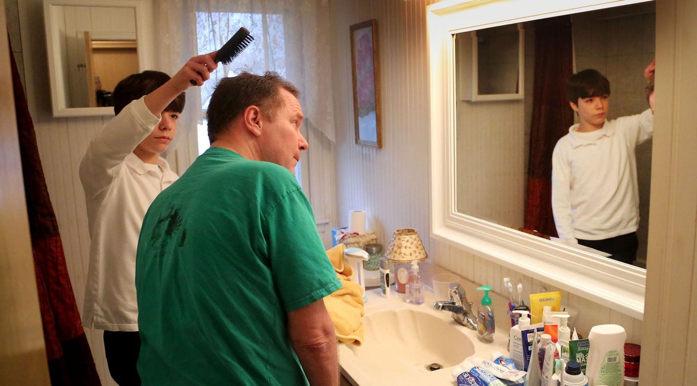 On a day Bob White, 47, who has A.L.S., volunteers at the school of his son, Kieran, 13, washes his father&#xed;s hair in the shower before brushing Bob&#xed;s hair. His father drives them to school later in the morning, and because of the physical deterioration the disease has caused in Bob&#xed;s limbs, Kieran shifts the red Hyundai Elantra from park into reverse for his father to back out of the driveway. The incurable condition has forced Kieran into a part-time role as a child caregiver.](D